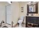 Bathroom featuring shower, toilet and vanity with black fixtures and a decorative mirror at 5604 S Lisbon Way, Centennial, CO 80015