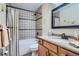 Cozy bathroom featuring shower-tub with decorative tiles and a stylish vanity with granite countertop at 5604 S Lisbon Way, Centennial, CO 80015