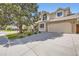 Charming two-story home with brick and siding, a well-manicured lawn, and an attached two-car garage at 5604 S Lisbon Way, Centennial, CO 80015