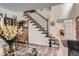 Elegant staircase with wood and iron details, leading to the upper level, adjacent to the living room at 5604 S Lisbon Way, Centennial, CO 80015