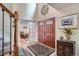 Grand foyer featuring double doors, tiled floors, a staircase, and high ceilings at 5604 S Lisbon Way, Centennial, CO 80015