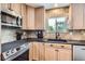 Well-equipped kitchen with stainless steel appliances, granite countertops, and ample cabinet space at 5604 S Lisbon Way, Centennial, CO 80015