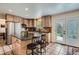 Spacious kitchen featuring an island with seating, tiled floors, and stainless steel appliances at 5604 S Lisbon Way, Centennial, CO 80015