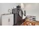 Well-equipped laundry room with a utility sink, plenty of storage, and a full-size washer and dryer at 5604 S Lisbon Way, Centennial, CO 80015