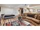 Finished basement offers versatile living with a large sectional sofa, Murphy bed and bar area at 5604 S Lisbon Way, Centennial, CO 80015