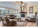 Spacious living room with a brick fireplace, high ceilings and large windows providing lots of natural light at 5604 S Lisbon Way, Centennial, CO 80015