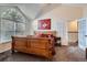 Bright main bedroom with vaulted ceiling, arched windows and a decorative wood bed frame at 5604 S Lisbon Way, Centennial, CO 80015