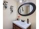 Stylish powder room with a vessel sink, dark wood vanity and elegant decorative touches at 5604 S Lisbon Way, Centennial, CO 80015