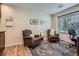 Cozy sitting area with two armchairs, a table and a window with bright natural light at 5604 S Lisbon Way, Centennial, CO 80015