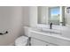 Powder bathroom features a sink, a faucet, and a mirror at 888 S Valentia St # 106, Denver, CO 80247