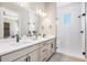 Elegant bathroom showcasing a dual sink vanity, sleek fixtures, and a large glass shower at 888 S Valentia St # 106, Denver, CO 80247