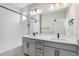 Modern bathroom features a double sink vanity, a large mirror, and a shower-tub combo at 888 S Valentia St # 106, Denver, CO 80247