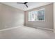 Bright bedroom features neutral carpet, ceiling fan, and double hung window at 888 S Valentia St # 106, Denver, CO 80247