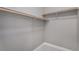 Walk-in closet with wood closet rods and neutral carpet at 888 S Valentia St # 106, Denver, CO 80247