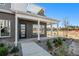 Stylish townhome featuring a brick facade, covered front porch, and manicured landscaping at 888 S Valentia St # 106, Denver, CO 80247