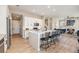 Modern kitchen with white cabinetry, marble counters, and a large island with seating at 888 S Valentia St # 106, Denver, CO 80247