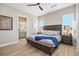 Spacious main bedroom suite with wood-look floors and en suite bathroom at 888 S Valentia St # 106, Denver, CO 80247