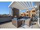 Relaxing rooftop deck featuring an outdoor fireplace, comfortable seating, and scenic views at 888 S Valentia St # 106, Denver, CO 80247