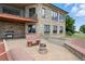 Backyard patio area with stone seating, a fire pit, and a view of the surrounding landscape at 31200 E 145Th Ave, Brighton, CO 80603