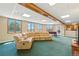 Finished basement with multiple windows, a comfortable L shaped couch, and entertainment options at 31200 E 145Th Ave, Brighton, CO 80603