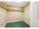 Walk-in closet in basement, featuring wooden clothing racks, bright lighting, and easy access at 31200 E 145Th Ave, Brighton, CO 80603