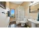 Bathroom featuring a glass block shower, sleek pedestal sink, and a picturesque window with a scenic view at 31200 E 145Th Ave, Brighton, CO 80603