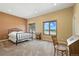 Spacious bedroom bathed in natural light, showcasing two windows with picturesque views and neutral decor at 31200 E 145Th Ave, Brighton, CO 80603