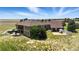 A vast home with a sprawling lawn and rear patio perfect for outdoor gatherings and leisure at 31200 E 145Th Ave, Brighton, CO 80603
