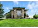 Attractive brick home with statues, garden beds, and lush lawn at 31200 E 145Th Ave, Brighton, CO 80603