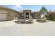 Home's front yard with a beautiful fountain, flower beds, and decorative rock features at 31200 E 145Th Ave, Brighton, CO 80603