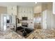 Well-lit kitchen boasts stainless steel appliances, white cabinetry, and a sink with granite countertops at 31200 E 145Th Ave, Brighton, CO 80603