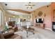 Open living space shows kitchen, sitting area, and fireplace with large windows for natural light at 31200 E 145Th Ave, Brighton, CO 80603