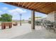 Outdoor patio with a brick pillar, various seating arrangements, and well-maintained concrete flooring at 31200 E 145Th Ave, Brighton, CO 80603