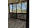 Screened balcony featuring views, wood-look flooring, and natural light through large windows at 3460 S Poplar St # 404, Denver, CO 80224