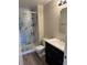 Bathroom showcases a glass walk-in shower, a modern vanity, and wood flooring at 3460 S Poplar St # 404, Denver, CO 80224