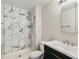 Modern bathroom featuring marble-tiled shower, updated sink, and contemporary design at 3460 S Poplar St # 404, Denver, CO 80224