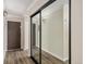 Inviting hallway features wood floors, modern lighting, and mirrored closet at 3460 S Poplar St # 404, Denver, CO 80224