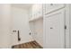 Functional laundry room with overhead cabinets, providing ample storage solutions at 3460 S Poplar St # 404, Denver, CO 80224