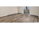 Spacious living room with sliding glass door to balcony and wood flooring at 3460 S Poplar St # 404, Denver, CO 80224