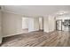 Open concept living room with wood flooring, and adjacent kitchen at 3460 S Poplar St # 404, Denver, CO 80224