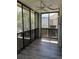 Inviting screened-in patio with fan, providing a relaxing space with outdoor views and laminate floor at 3460 S Poplar St # 404, Denver, CO 80224