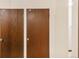 Storage units with wooden doors and numbered labels in a white-walled corridor at 3460 S Poplar St # 404, Denver, CO 80224