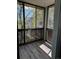 Enclosed sun room with floor-to-ceiling windows and wood-look flooring, offering natural light at 3460 S Poplar St # 404, Denver, CO 80224