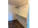 Functional walk-in closet with wire shelving and laminate flooring for organized storage at 3460 S Poplar St # 404, Denver, CO 80224