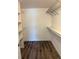 Spacious walk-in closet with wire shelving and laminate flooring for efficient organization at 3460 S Poplar St # 404, Denver, CO 80224