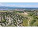 Scenic aerial view of a residential area near a lake, featuring winding roads and well-maintained homes at 2548 Foothills Canyon Ct, Highlands Ranch, CO 80129