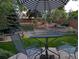 Secluded backyard featuring an umbrella table set, tiered landscaping, and privacy fence at 2548 Foothills Canyon Ct, Highlands Ranch, CO 80129