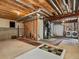 Unfinished basement with exposed ceiling rafters, water heater, and gray carpet squares at 2548 Foothills Canyon Ct, Highlands Ranch, CO 80129