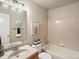 Bathroom featuring a shower/tub combo, sink vanity, floral art, and light tile at 2548 Foothills Canyon Ct, Highlands Ranch, CO 80129