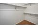 A walk-in closet features white walls, brown carpet, and metal rods for hanging clothes at 2548 Foothills Canyon Ct, Highlands Ranch, CO 80129